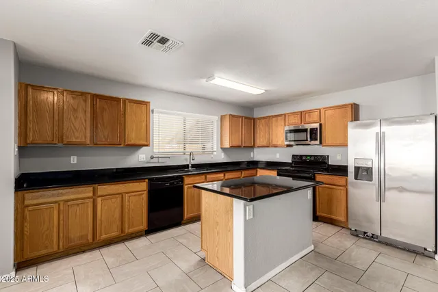a kitchen with a sink stove and refrigerator