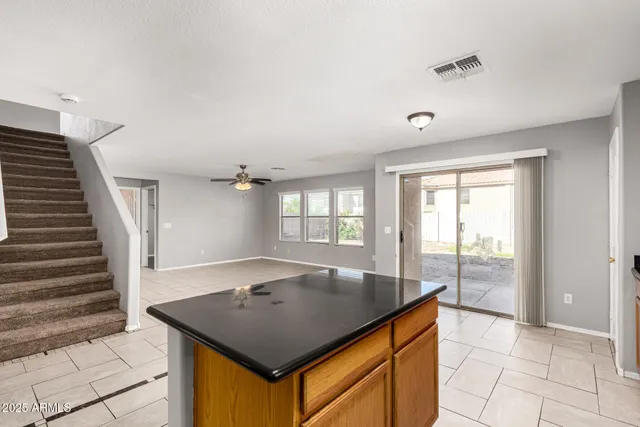 a room with pool table and windows