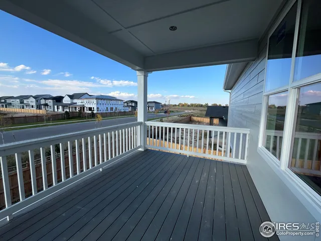 a view of a balcony with wooden floor
