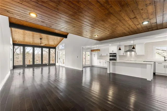 a view of a hallway with wooden floor and fireplace