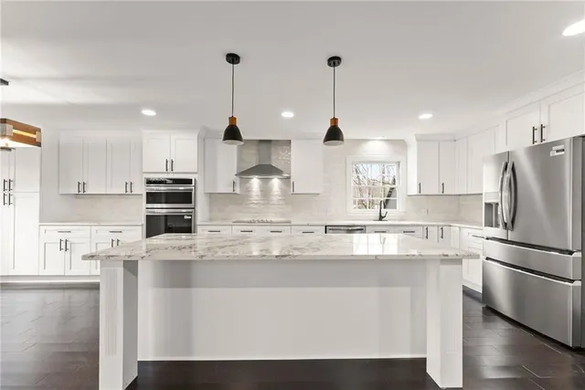 a living room with lots of furniture and kitchen view