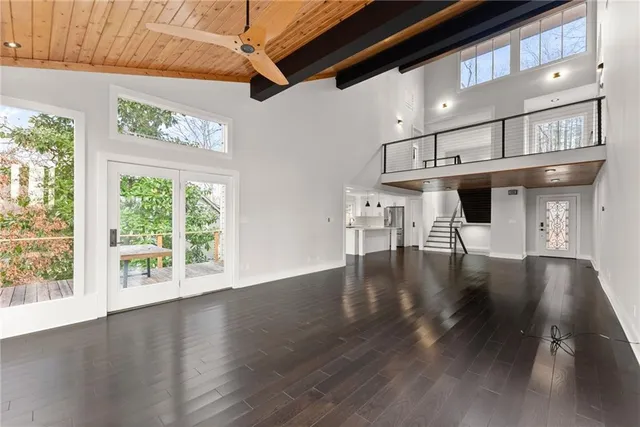 a bathroom with a granite countertop sink toilet and mirror