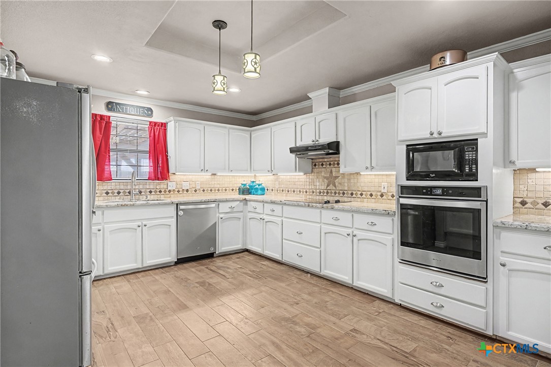 1601 Sunset Circle Cameron, TX 76520 - Photo 17 of 40 a kitchen with a white cabinets and white appliances