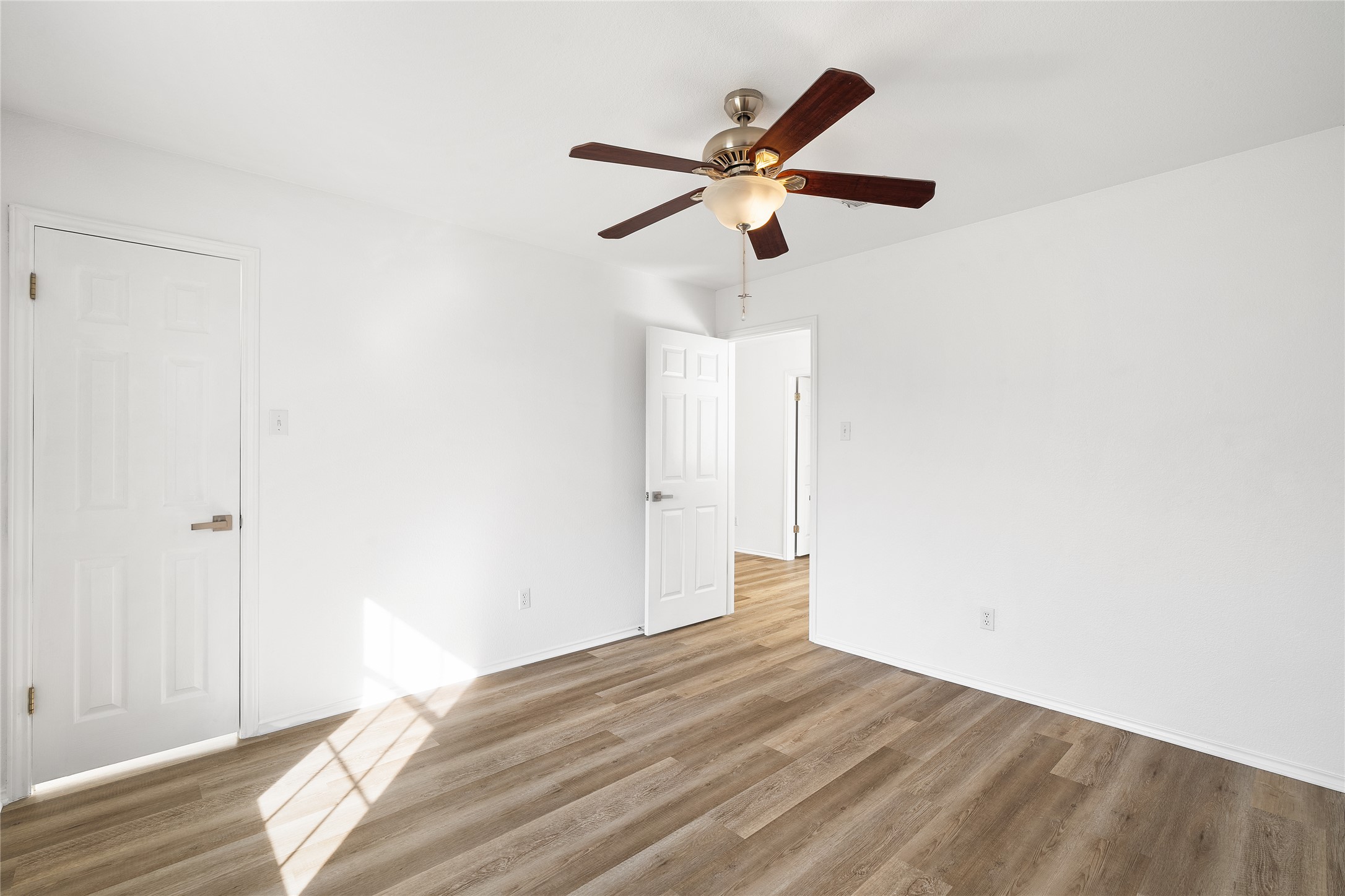 206 River Down Road Georgetown, TX 78628 - Photo 24 of 39 Room featuring light wood-finish flooring, white walls, and a ceiling fan with integrated lighting
