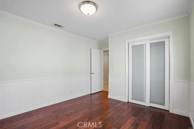 an empty room with wooden floor