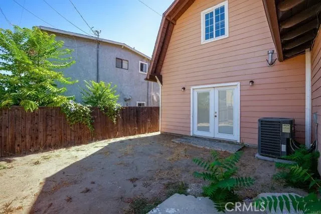 a view of a house with a small yard and potted plants