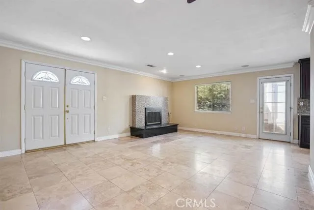 a view of empty room with windows and cabinet
