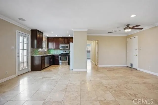 a view of kitchen with stainless steel appliances granite countertop a refrigerator and a sink