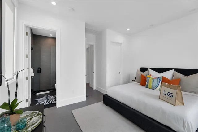 a view of an empty room with a window and a flat screen tv