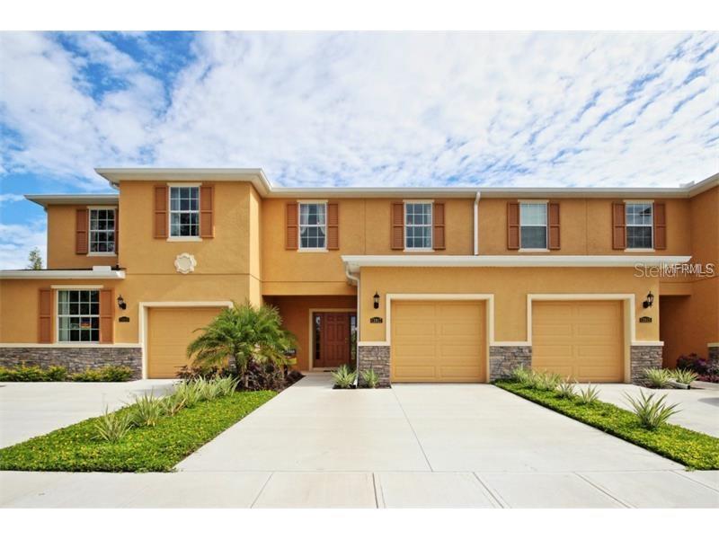 8442 Pine River Road Tampa, FL 33637 - Photo 1 of 1 a front view of a house with a yard and a garage