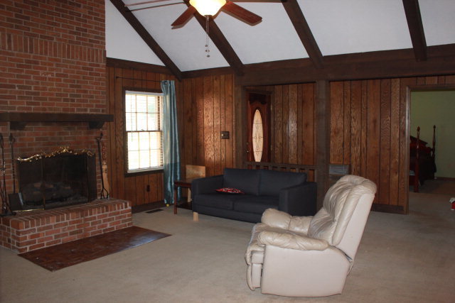 6350 Sandy Point Road Lizella, GA 31052 - Photo 3 of 25 a living room with furniture and a fireplace