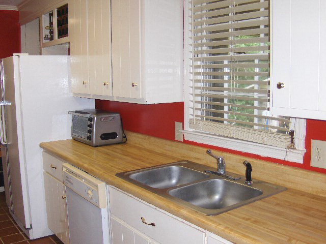 6350 Sandy Point Road Lizella, GA 31052 - Photo 7 of 25 a kitchen with a sink and a refrigerator