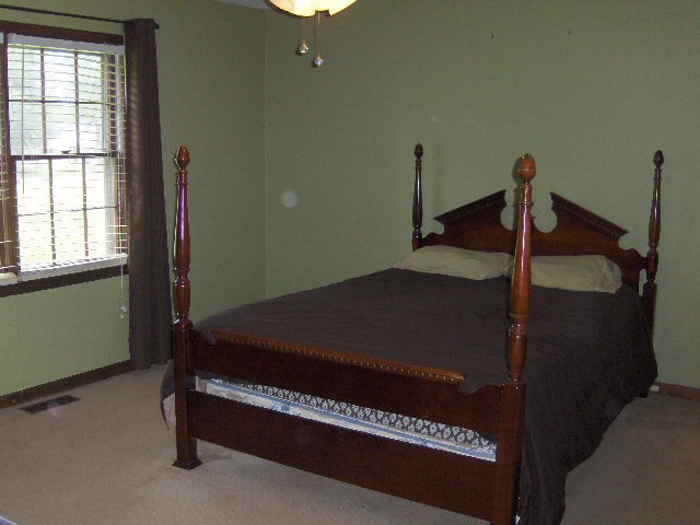 6350 Sandy Point Road Lizella, GA 31052 - Photo 9 of 25 a bed sitting in a room next to a window