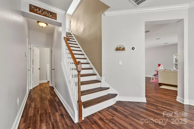 a view of a hallway with wooden floor and entryway