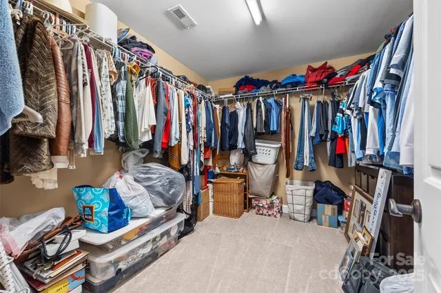 a view of walk in closet with clothes