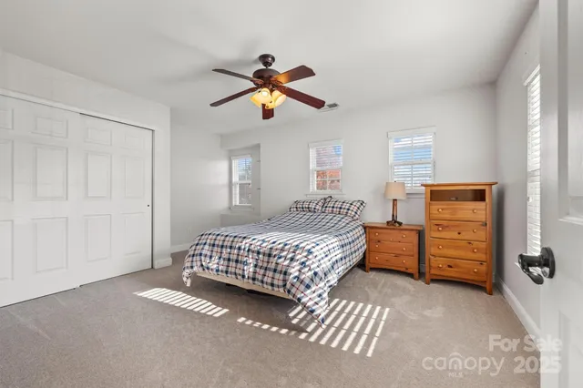 a bedroom with a bed and cabinets