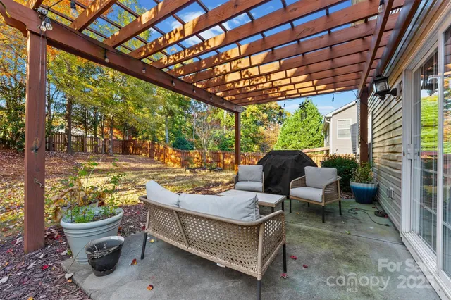 a view of a porch with furniture and floor to ceiling window