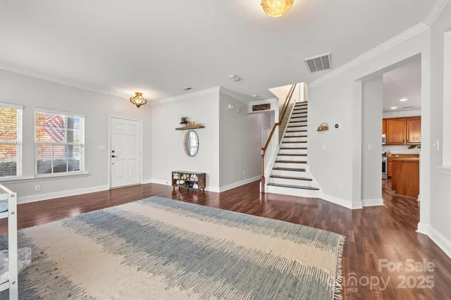 a bedroom with wooden floors and a bed
