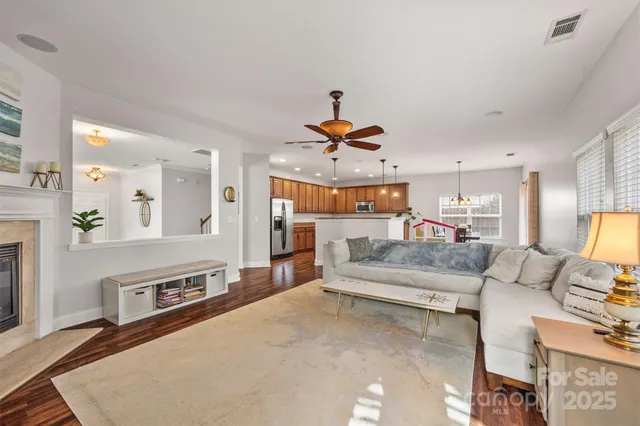 a living room with furniture and a chandelier