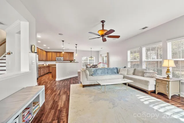 a living room with furniture and kitchen view