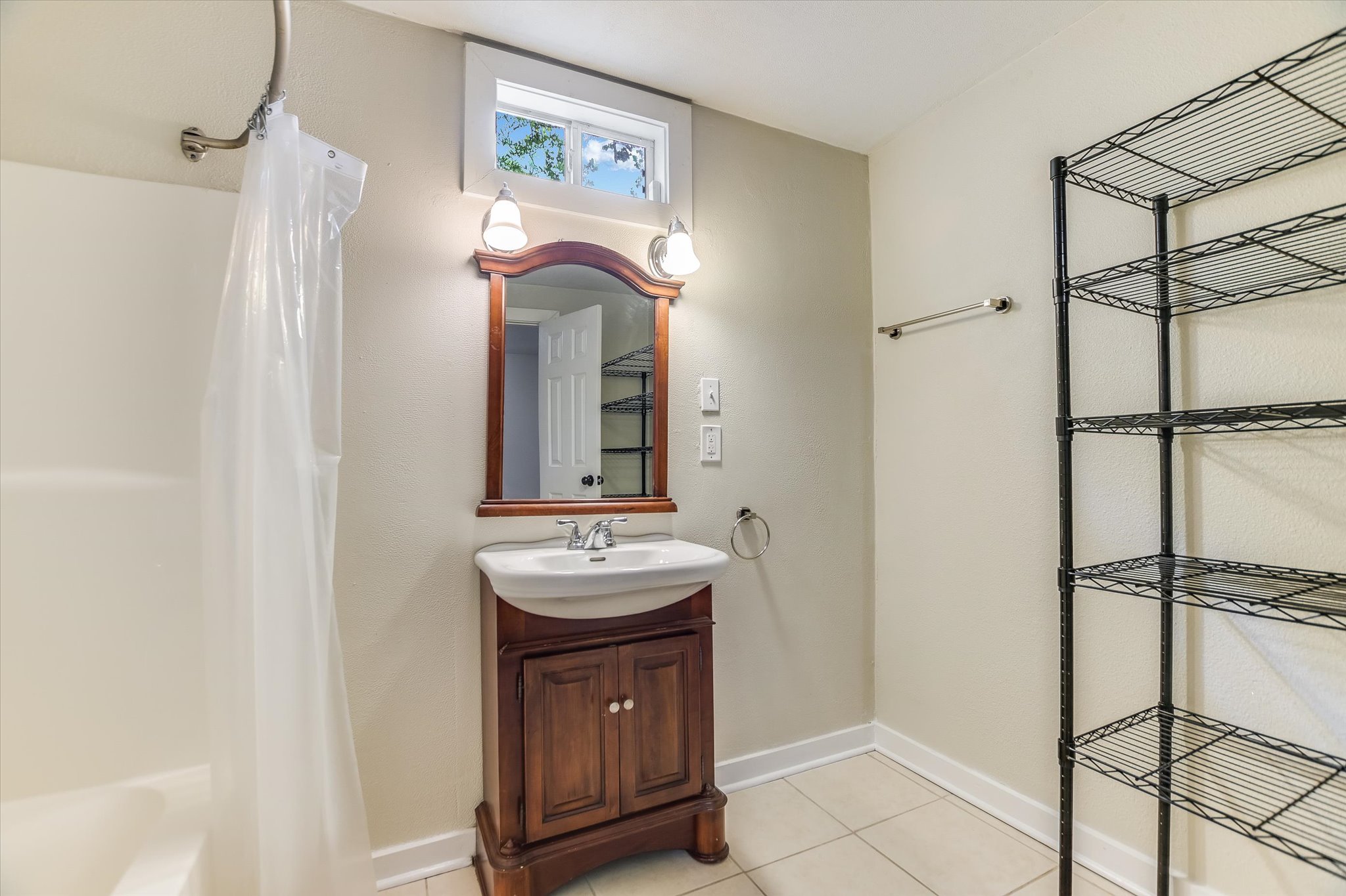 208 Braeswood Road Austin, TX 78704 - Photo 12 of 20 A well-appointed bath features tile flooring and a vanity with a white basin and storage.