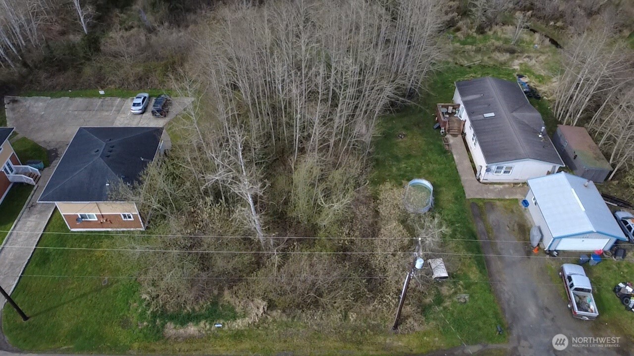 812 Thomas Street Aberdeen, WA 98520 - Photo 7 of 13 an aerial view of a house with a yard and lake view