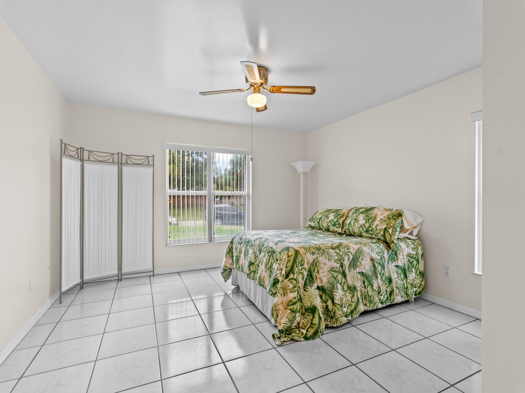 992 Seneca Avenue Sebastian, FL 32958 - Photo 19 of 26 a living room with a bed and a chandelier