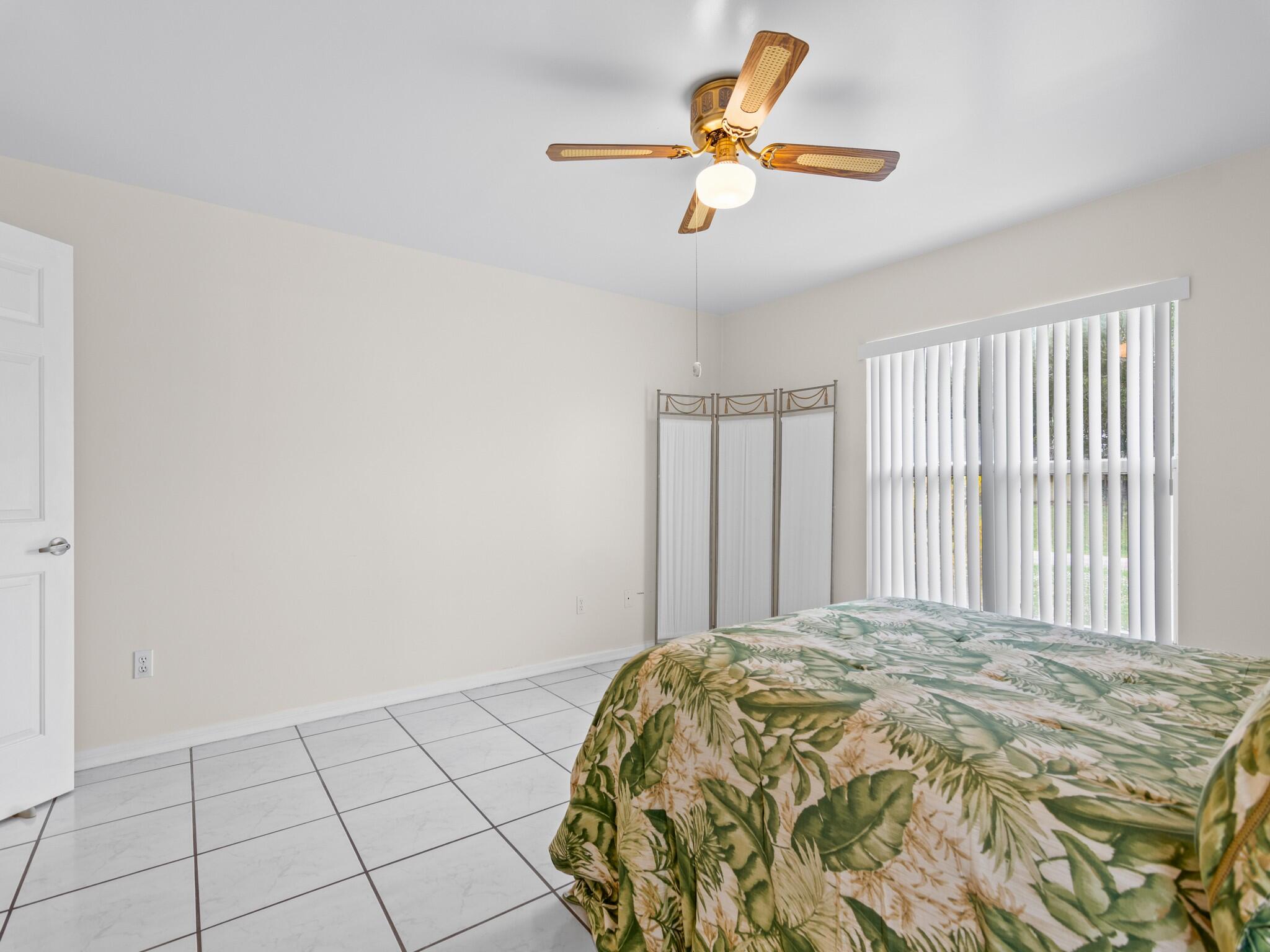 992 Seneca Avenue Sebastian, FL 32958 - Photo 20 of 26 a bed sitting in a bedroom next to a window