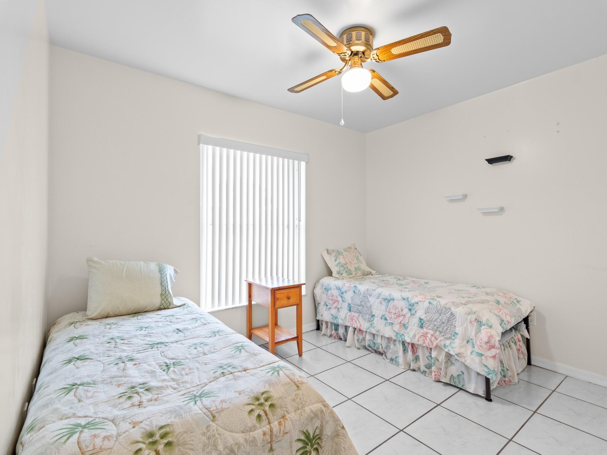 992 Seneca Avenue Sebastian, FL 32958 - Photo 21 of 26 a bedroom with a bed and a chandelier
