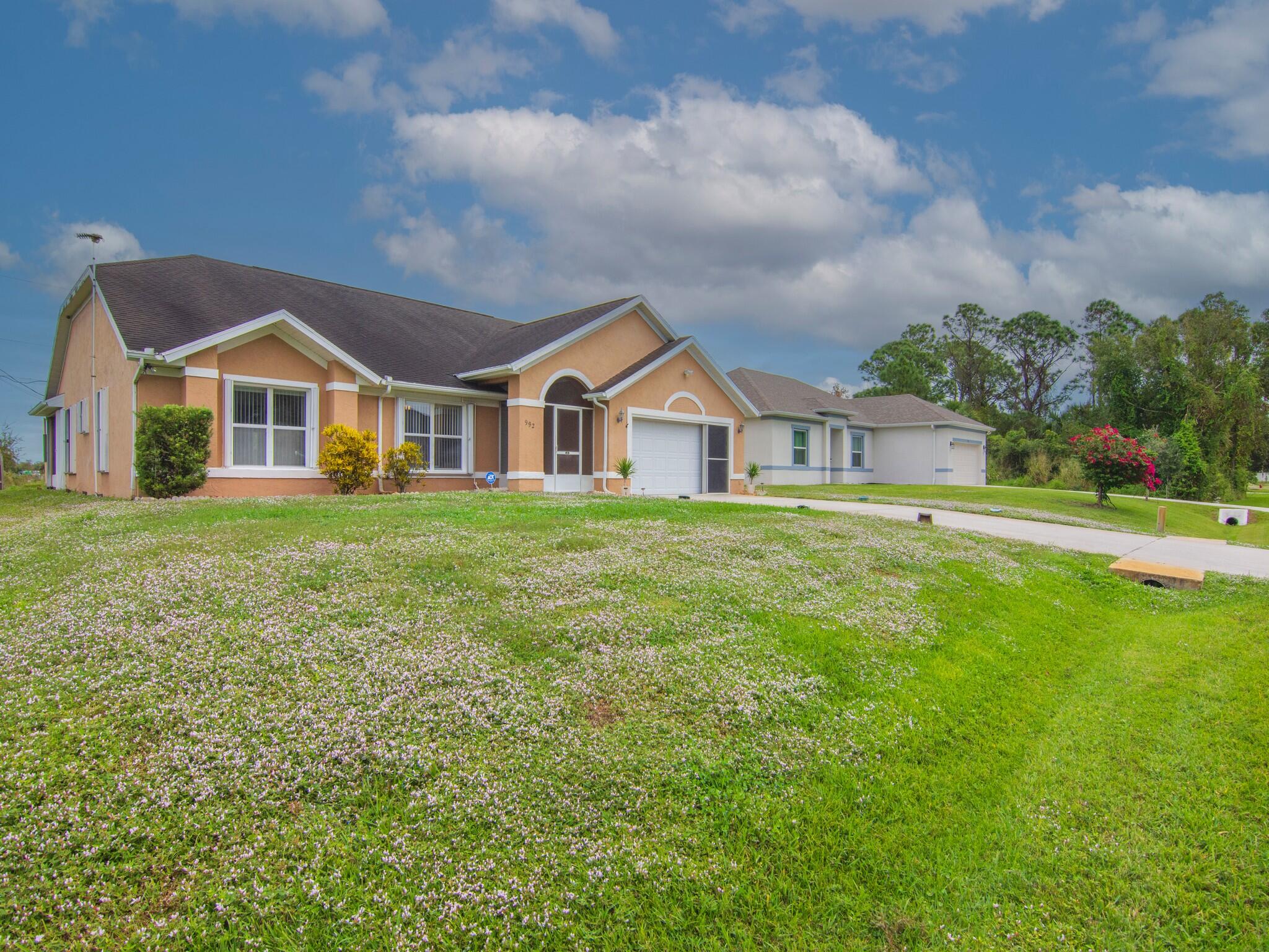 992 Seneca Avenue Sebastian, FL 32958 - Photo 3 of 26 a view of a house with a big yard and large trees