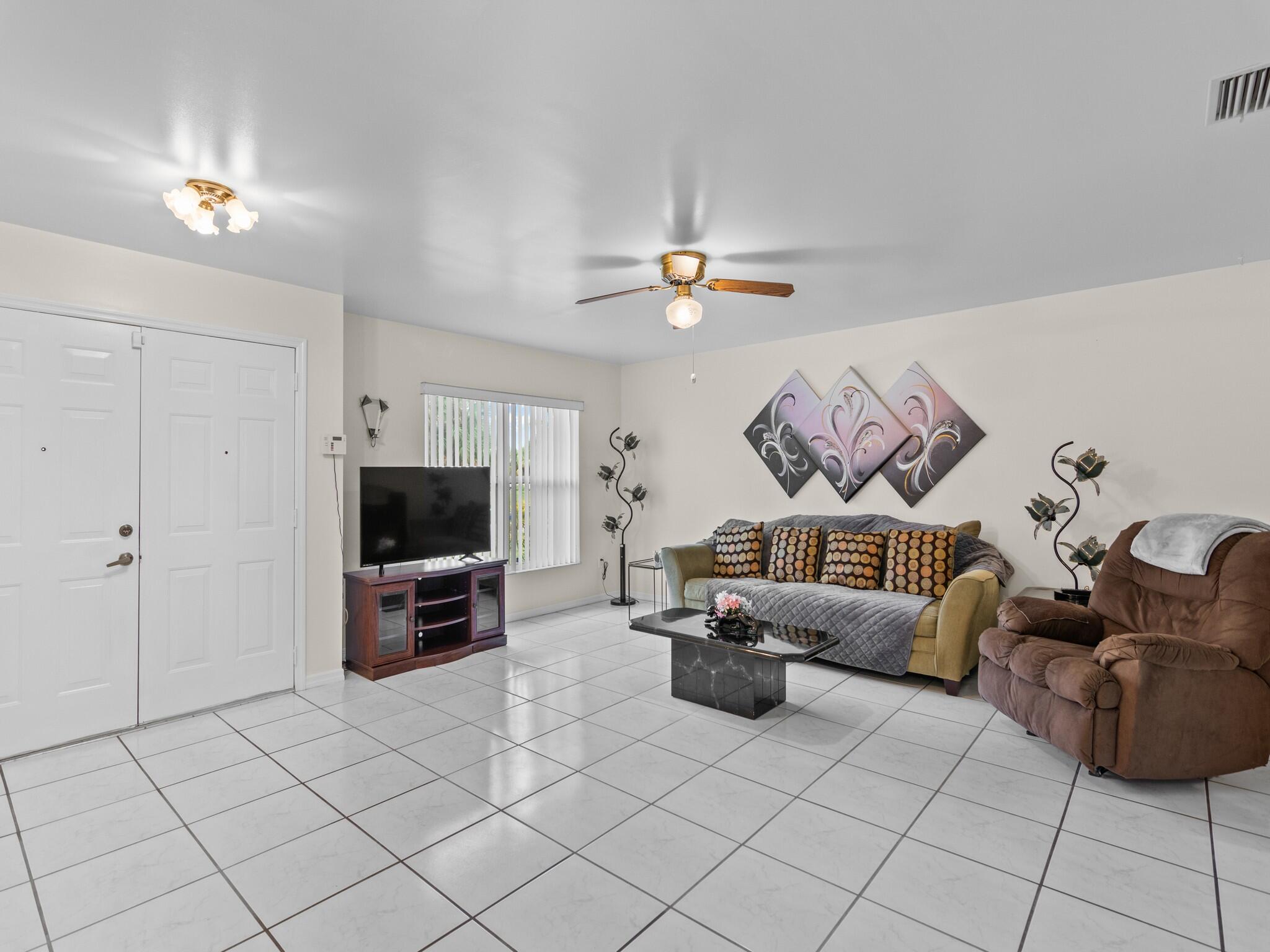 992 Seneca Avenue Sebastian, FL 32958 - Photo 4 of 26 a living room with furniture and a flat screen tv