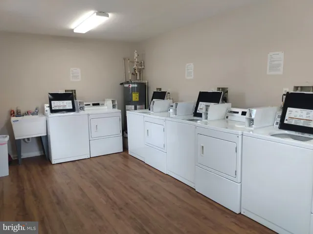 a utility room with cabinets dryer and washer