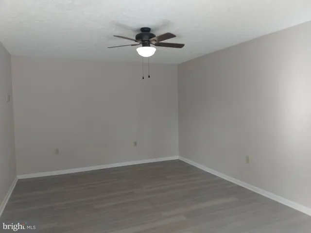 a view of a small space with wooden floor and a window