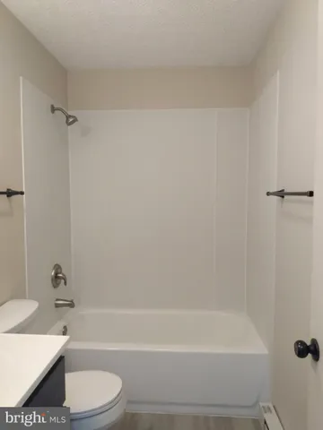 a bathroom with a bathtub and a toilet