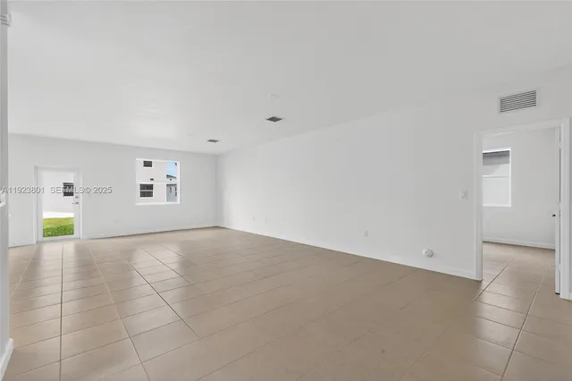 a view of a kitchen with refrigerator and a sink