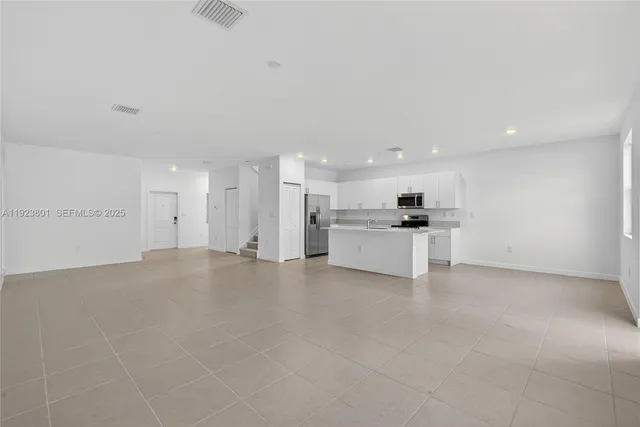 a white toilet sitting next to a shower