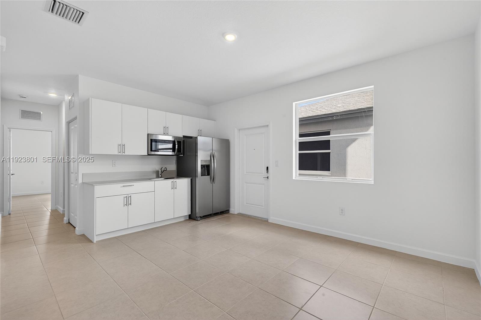 19431 Southwest 340th Street Homestead, FL 33034 - Photo 15 of 48 a view of a kitchen with refrigerator and window