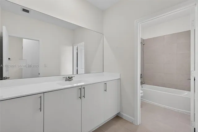 a white bath tub sitting next to a toilet