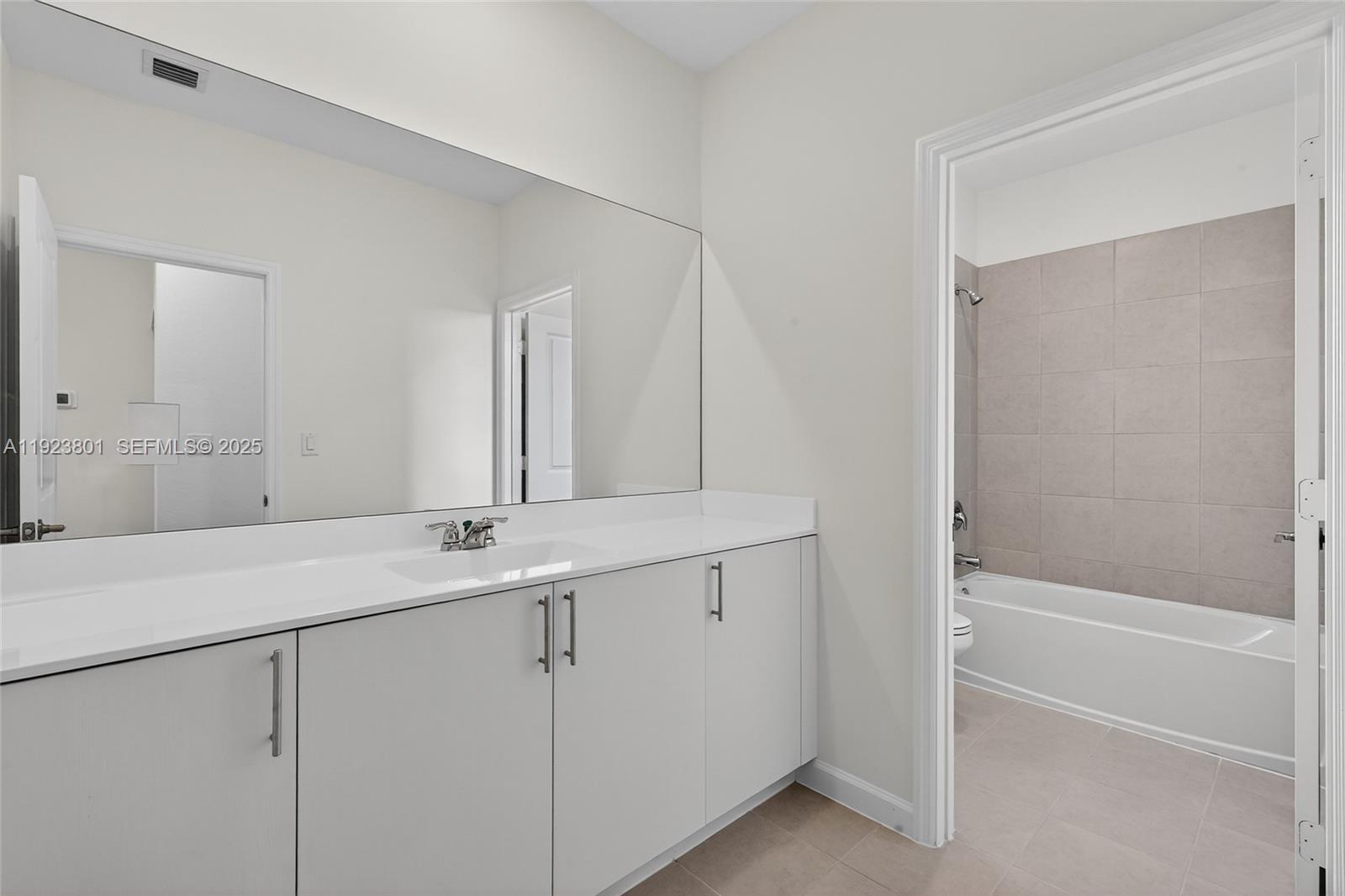 19431 Southwest 340th Street Homestead, FL 33034 - Photo 17 of 48 a bathroom with a granite countertop sink and a mirror
