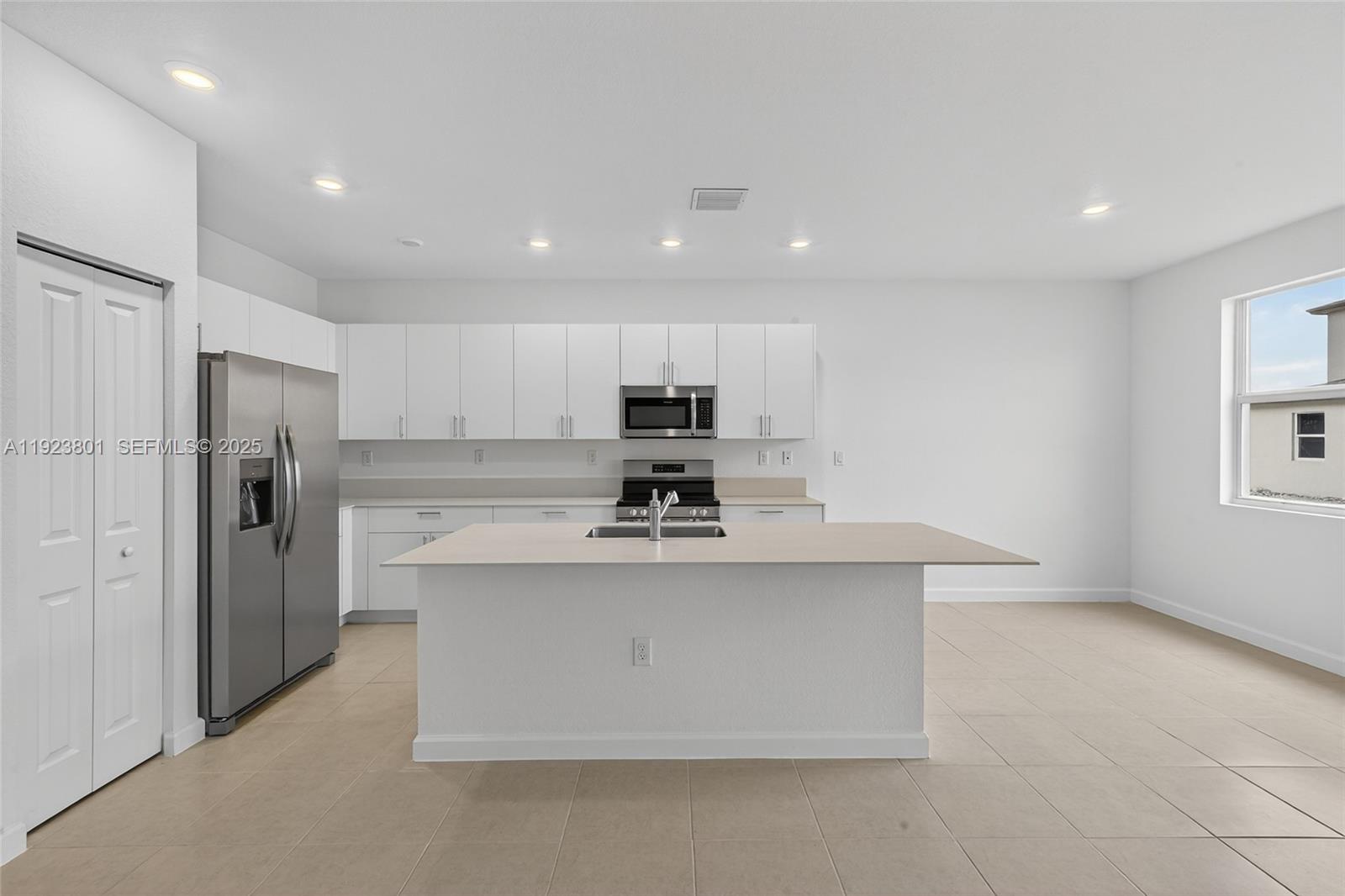 19431 Southwest 340th Street Homestead, FL 33034 - Photo 2 of 48 a view of kitchen with stainless steel appliances granite countertop a stove top oven a refrigerator and a cabinets