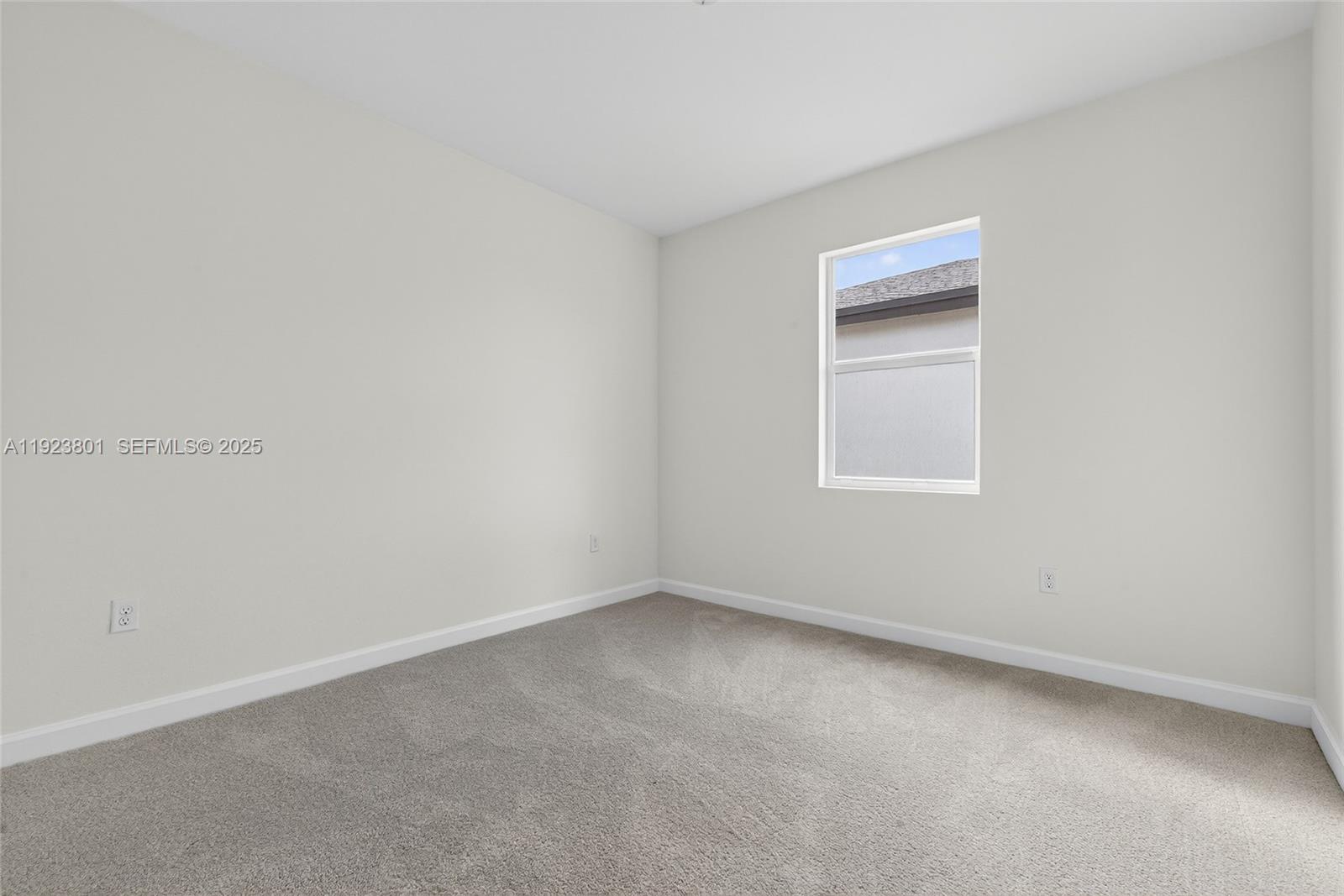 19431 Southwest 340th Street Homestead, FL 33034 - Photo 22 of 48 an empty room with a window