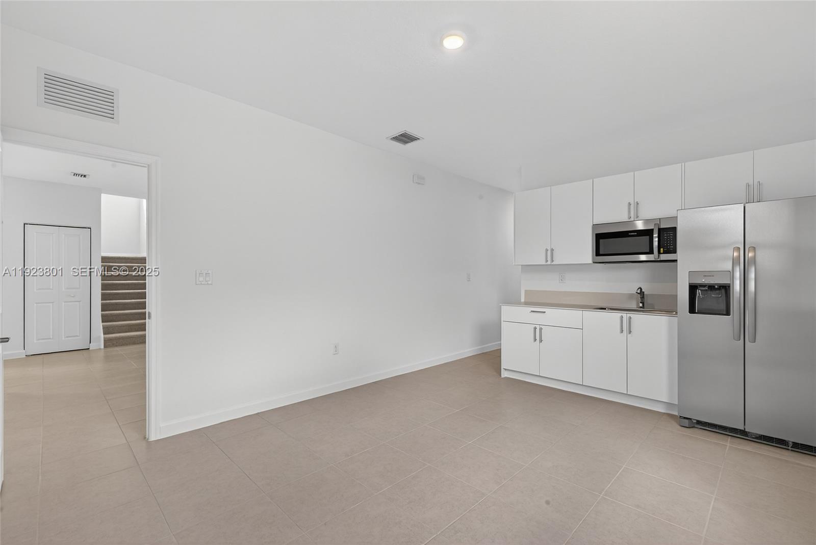 19431 Southwest 340th Street Homestead, FL 33034 - Photo 26 of 48 a large white kitchen with white stainless steel appliances