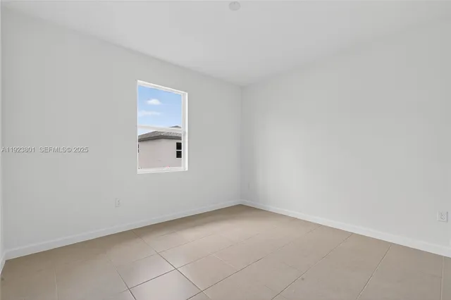 a view of a hallway with wooden floor and a bathroom