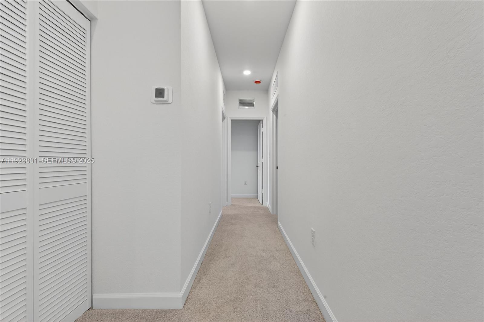 19431 Southwest 340th Street Homestead, FL 33034 - Photo 31 of 48 a view of a hallway with wooden floor and a bathroom