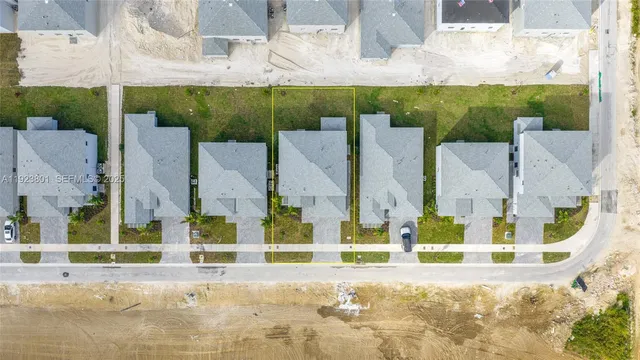 an aerial view of a house with a yard and lake view