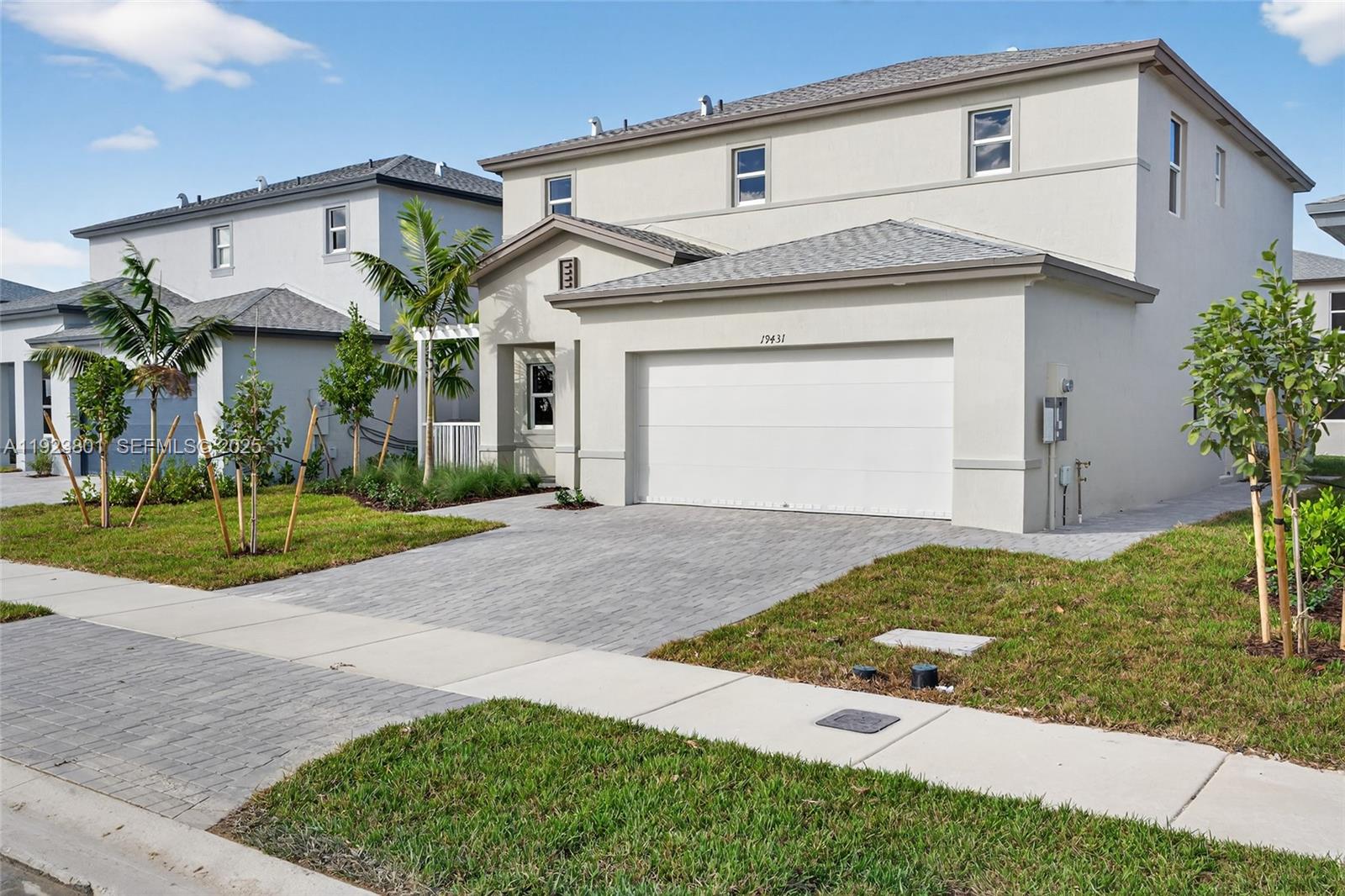 19431 Southwest 340th Street Homestead, FL 33034 - Photo 4 of 48 a front view of a house with a yard and garage