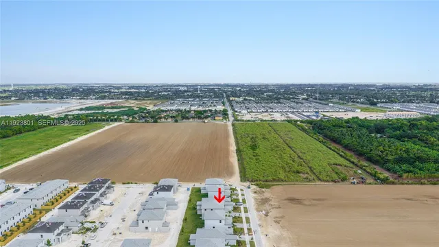 an aerial view of a house with a big yard and ocean view