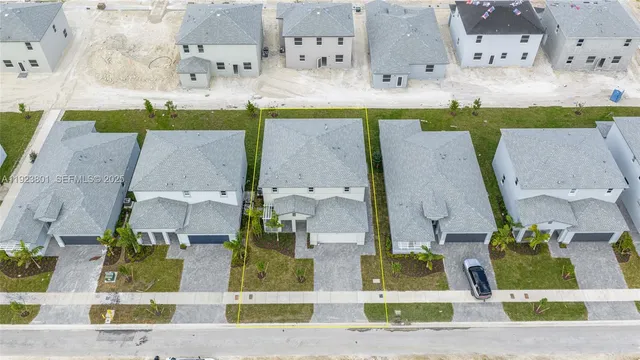an aerial view of a house with a yard