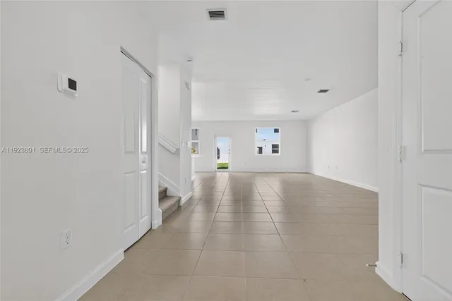 a view of a livingroom with wooden floor and stairs