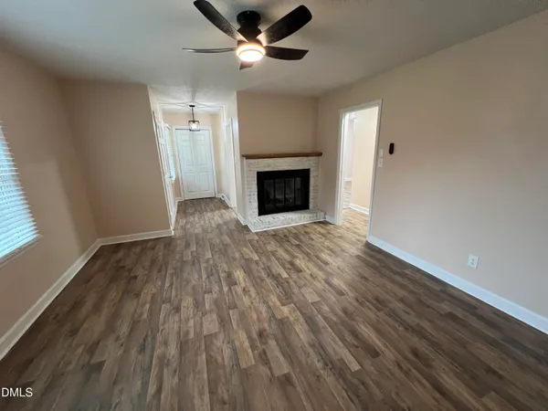 wooden floor in an empty room with a fireplace
